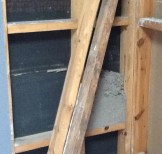 The gray stuff is the mouse nest.  The black sections are the interior side of our exterior wall.  Whole-house insulation has been added to the Neverending List of Things to Do.